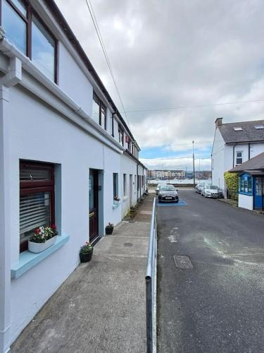 an empty street next to a white building at Home in Dungarvan in Dungarvan