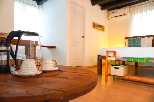 a room with a table with a tea pot on it at Vito Hotel Boutique Taganga in Taganga