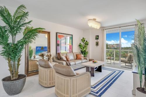 a living room with a couch and chairs and palm trees at Lux 3BR City-View Retreat in Hollywood, 2nd Floor in Hollywood