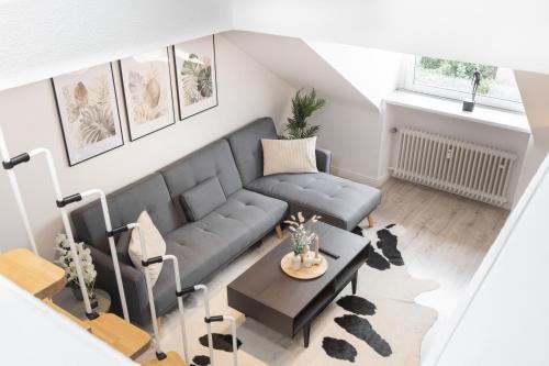 a living room with a couch and a table at Mc‘Maggies Atelier in Meerbusch