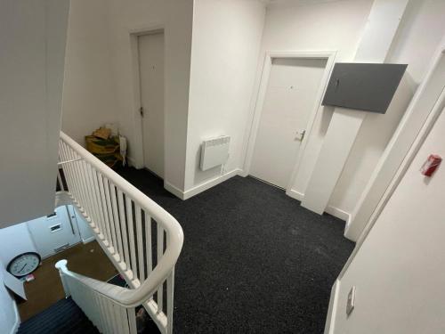 an empty room with a staircase and a door at Easy home in Manchester