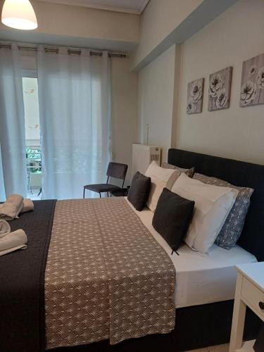 a bedroom with a large bed with white pillows at Volos Studio Stella in Volos