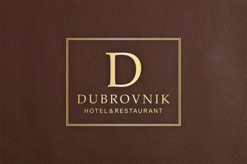 a book with the letter d in a gold frame at Hotel Dubrovnik in Marktoberdorf
