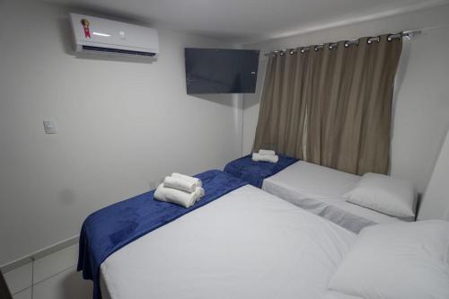 a bedroom with two beds with towels on them at Israel flat Tambau 115 in João Pessoa