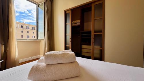 a bedroom with a bed with two towels on it at La Fontana Luxury Apartment in Nettuno