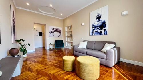 a living room with a couch and a table at La Fontana Luxury Apartment in Nettuno