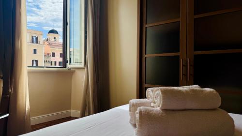 a hotel room with a bed and a window at La Fontana Luxury Apartment in Nettuno