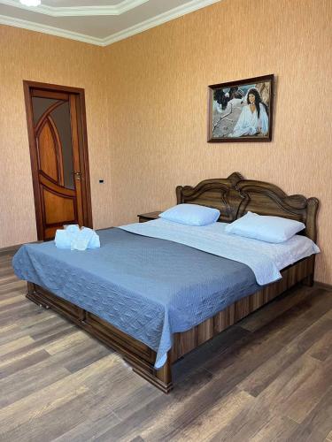 a bedroom with two beds and a picture on the wall at Riverside Cottage Poti in Poti