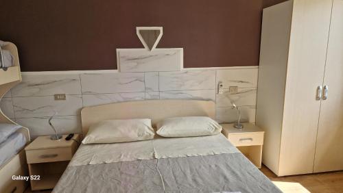 a bedroom with a bed with a white wall at Aria e sole in Caulonia