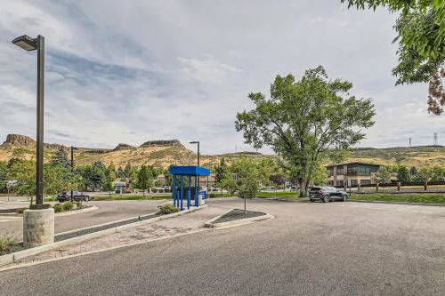 a street with a parking lot with mountains in the background at Golden Getaway Spacious 2BR Walk to Trails in Golden