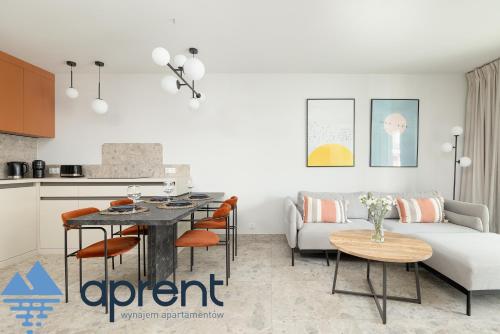 a living room with a couch and a table at Apartament Sun&Moon PBA - Aprent in Pobierowo