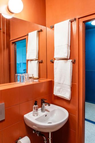 a bathroom with a sink and a mirror and towels at Pannonia View Delight in Budapest