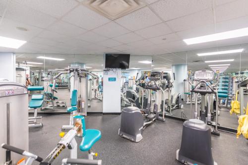 a gym with a lot of machines and a mirror at 10th Floor Oasis Stunning 2BR with Spacious Private Double Balcony at The Wyndahm Ocean Walk Resort in Daytona Beach