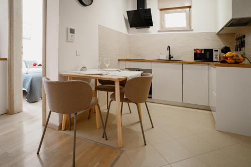 a kitchen with a wooden table and chairs at Montehome in Becici