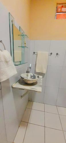 a white bathroom with a sink and a mirror at São Francisco Hause in Tatajuba