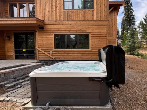 a hot tub sitting in front of a house at Arcadia Manor on the West Shore - Newly Built - 5 BR w Wet Bar EV Charger and Air Conditioning in Tahoe City