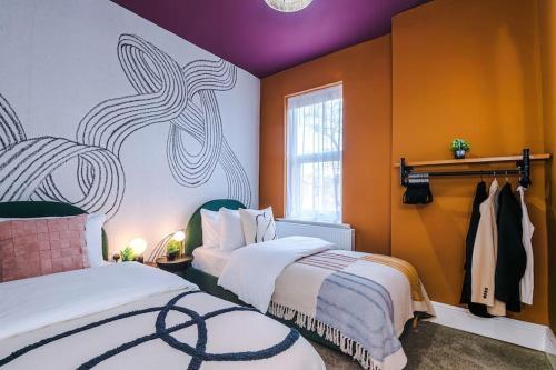 a bedroom with two beds and a painting on the wall at Modern 4-Bedroom in Manchester in Manchester