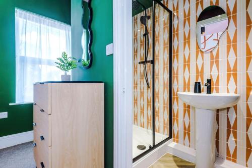 a bathroom with a sink and a shower at Modern 4-Bedroom in Manchester in Manchester