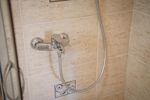 a shower in a bathroom with a shower head at Montehome in Becici