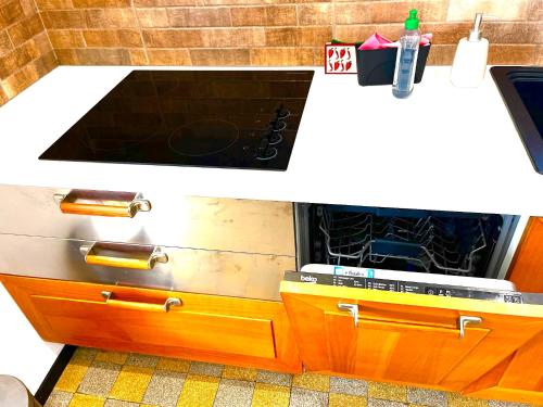 two pictures of a kitchen with a stove in it at Villa Cantarela, Palavas plage, Vue mer in Palavas-les-Flots