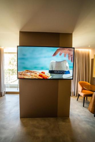 a flat screen tv on a wall in a living room at Oceana Atlântico Hotel & SPA in João Pessoa