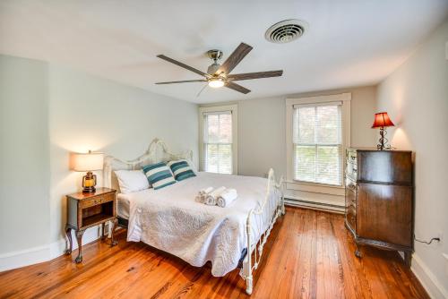 a bedroom with a bed and a ceiling fan at 15 Mi to Gloucester Waterfront Mathews Home! in Onemo