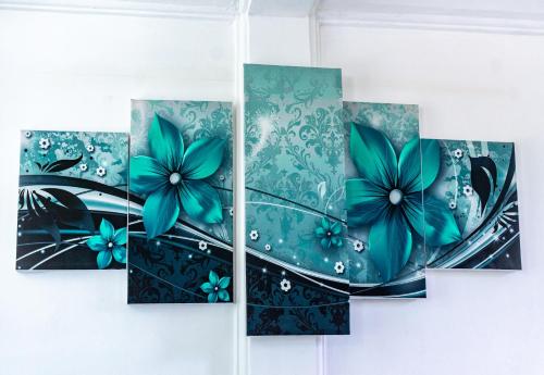 a painting of blue flowers on a wall at Rainbow Heights Apartment, Soufriere in Soufrière