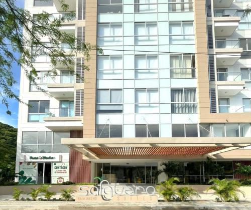 a large apartment building with a building at Salguero Suites - Playa Salguero - By INMOBILIARIA VS in Santa Marta