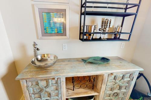 a bathroom with a sink and a mirror at Downward Dog in Inlet Beach