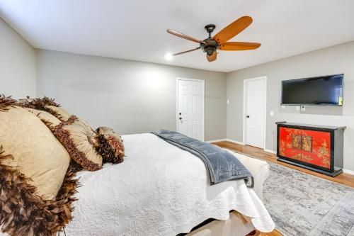 a bedroom with a ceiling fan and a fireplace at Deck and Views Spacious Lake House Escape in Hodgen