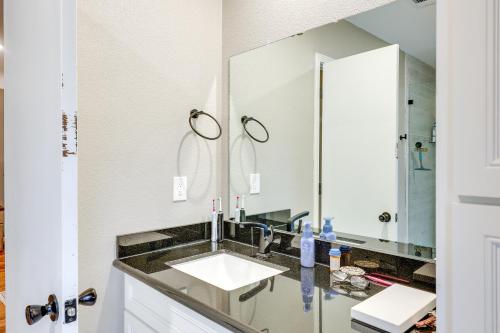 a bathroom with a sink and a mirror at Deck and Views Spacious Lake House Escape in Hodgen