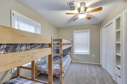 a bedroom with two bunk beds and a ceiling fan at Deck and Views Spacious Lake House Escape in Hodgen