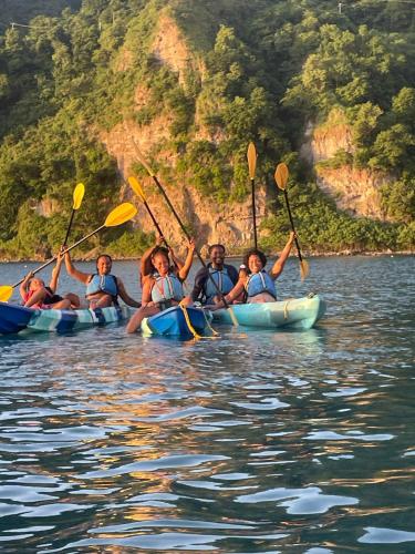 a group of people in kayaks on the water at Rainbow Heights Apartment, Soufriere in Soufrière
