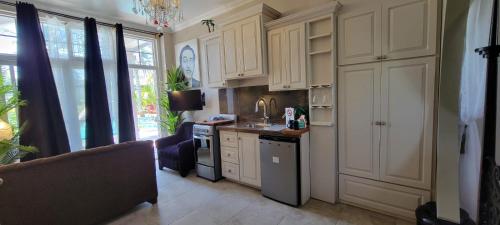 une cuisine avec des armoires blanches et un comptoir dans l'établissement Caye Caulker Boutique Guesthouse 3, à Caye Caulker