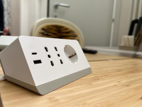 a white toaster sitting on top of a wooden floor at Mercadante Suite Central City in Milan