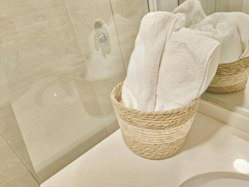 two baskets of towels sitting on a counter in a bathroom at Comodo y equipado departamento en la Av Juan de la Rosa in Calacala