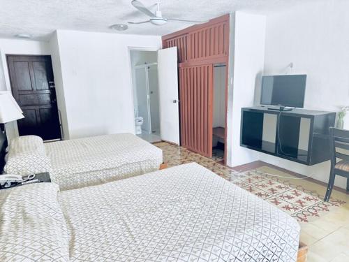 Кровать или кровати в номере Hotel Posada del Mar