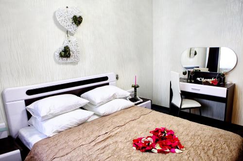 a bedroom with a large bed with flowers on it at Hotel Prestige in Barnaul