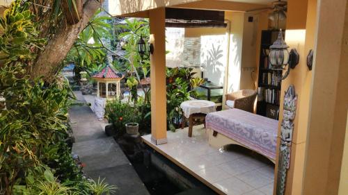 a bedroom with a bed and a pool in a garden at Ayu Taman Sari in Candidasa