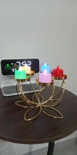 a group of candles on a table with a cell phone at Dhadi Doodz Travellers Inn in San Agustin