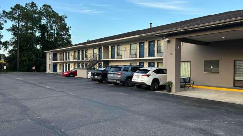 a parking lot in front of a building with cars parked at Motel 6-Macclenny, FL in Macclenny