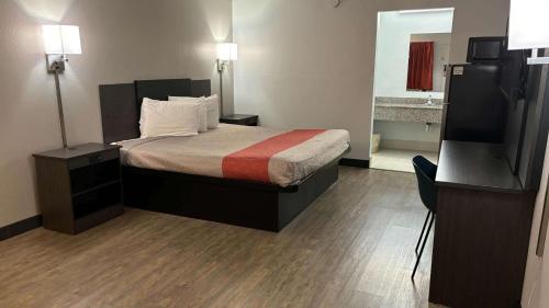 a small hotel room with a bed and a television at Motel 6-Macclenny, FL in Macclenny