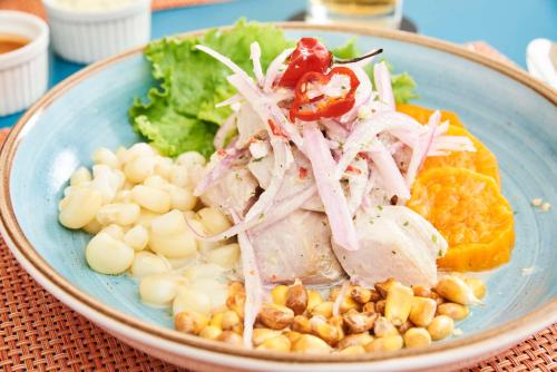 a plate of food with meat and vegetables on a table at Libre Hotel, BW Signature Collection by Best Western in Lima