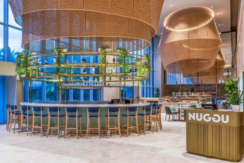 a rendering of a restaurant with a bar and chairs at Hilton Santa Marta in Santa Marta