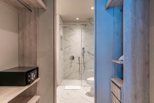 a bathroom with a shower with a glass door at Hilton Santa Marta in Santa Marta