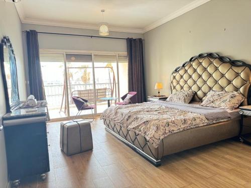 a bedroom with a large bed with a large headboard at درة العروس الحالمة in Durat  Alarous