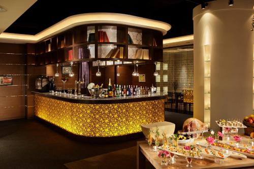 a bar in a restaurant with a lot of food at Hotel Terrace The Square Hitachi in Hitachi