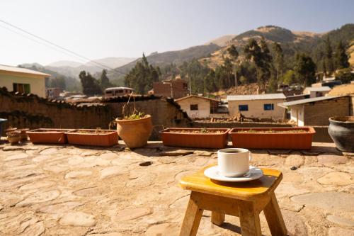 a hat sitting on a stool on a roof at Pachamama Hospedaje & Restaurant Pitumarca in Checacupe