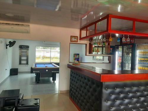 a bar with a pool table in a room with a pool table at HOTEL y RESTAURANTE RANCHO GRANDE in Cicuco
