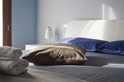 a bed with two pillows on top of it at La Corte D'Emilio B&B in Vignola